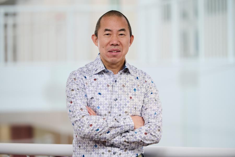 Image of a man wearing a printed shirt. 